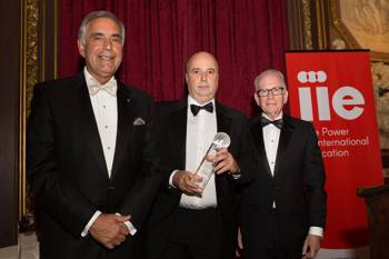Andreas Dracopoulos, President of the Stavros Niarchos Foundation, holding an award and being photographed with other men